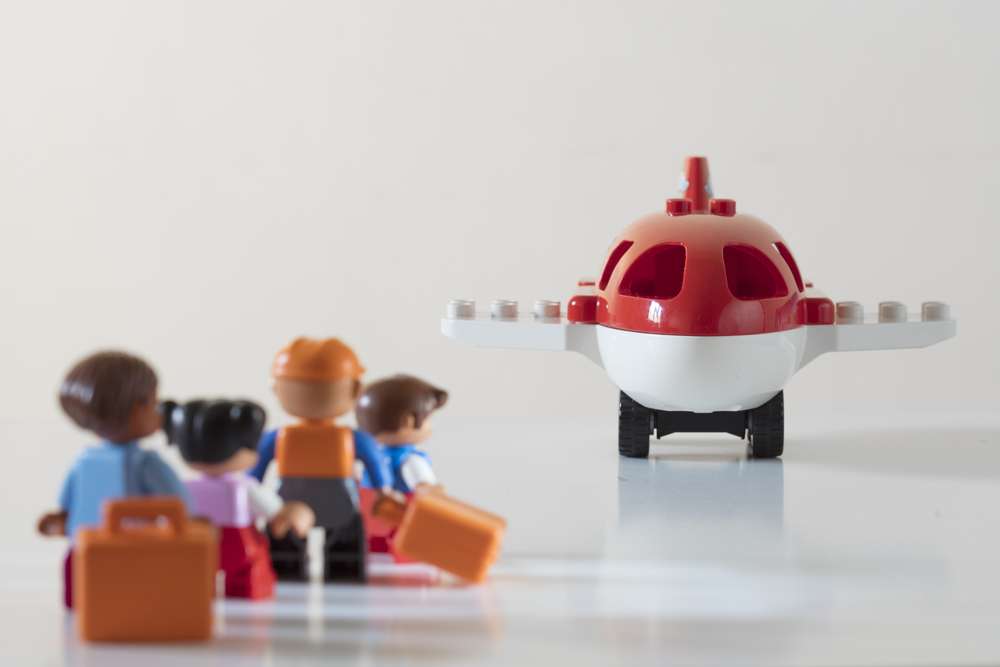 Passengers,Boarding,An,Airplane.,Plastic,Toys,On,White.,Focus,On