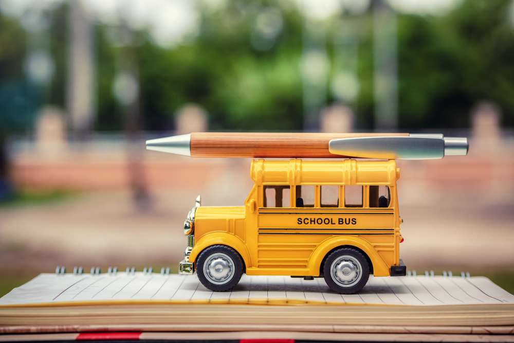 Education,Concept.,School,Bus,Model,And,Pen,On,Book,And