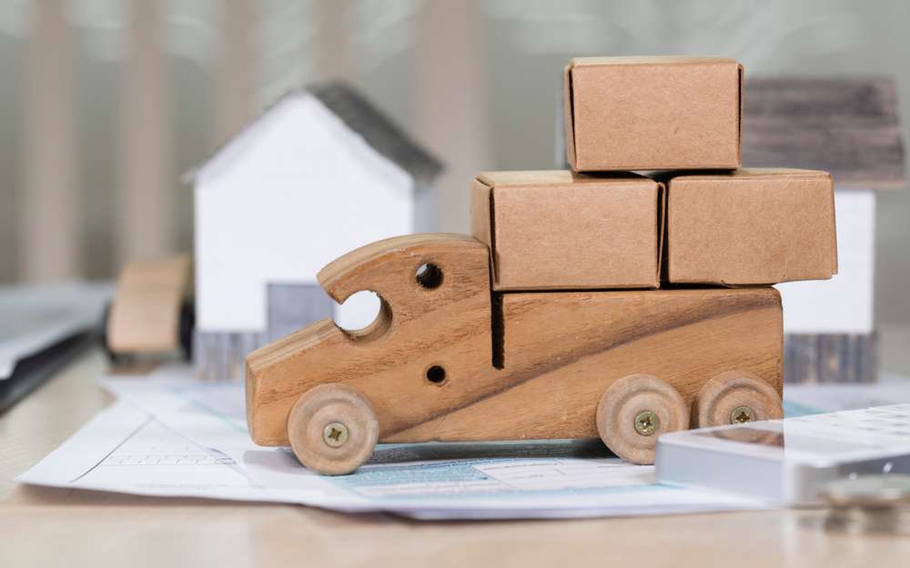 Small,Wooden,Truck,Loaded,With,Carton,Boxes,For,Moving.,Closeup
