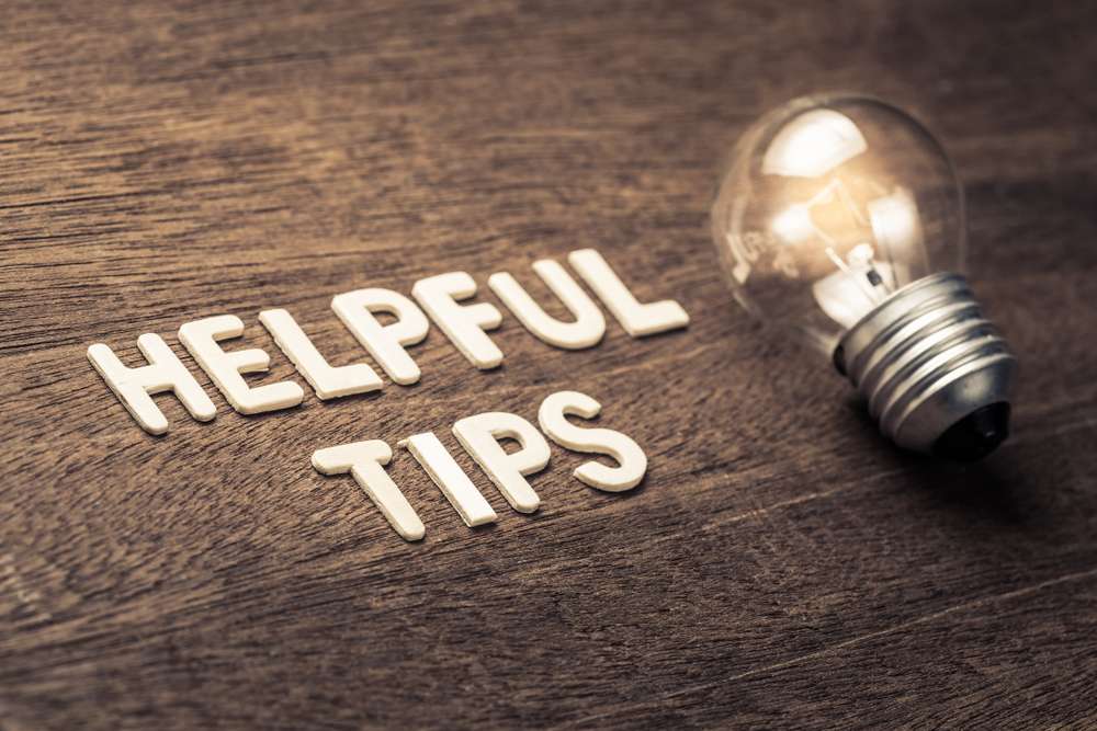 Helpful,Tips,Text,With,Glowing,Light,Bulb,On,Wood,Texture